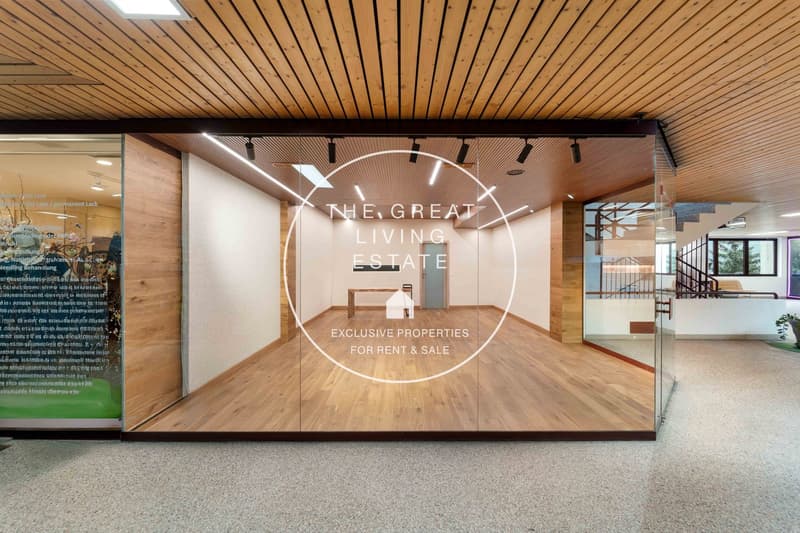 Open floor plan with hardwood floors, modern office building entrance, glass walls, wooden ceiling, large windows, modern design