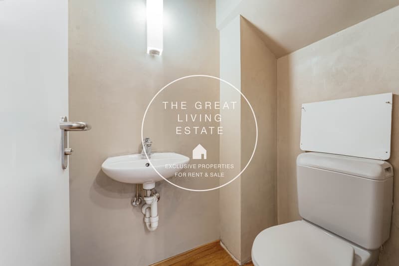 small white bathroom with sink and toilet