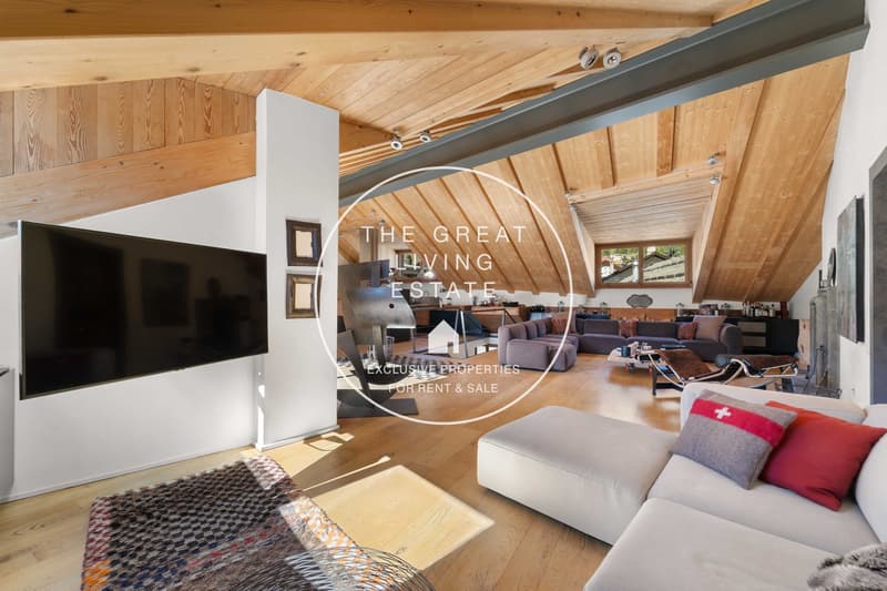 large flat screen TV, wooden ceiling, rug, white sofa, couch, pillows, table