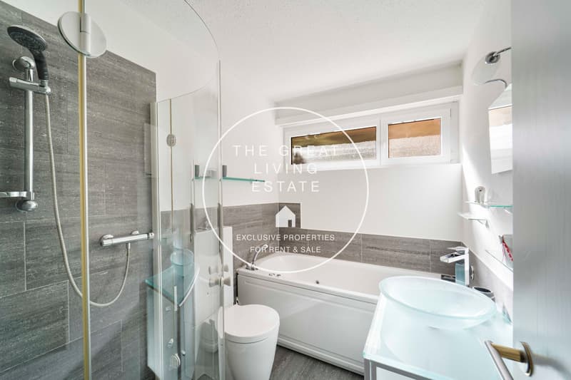 a modern bathroom featuring a shower, toilet, bathtub, and vanity with a sink and mirror