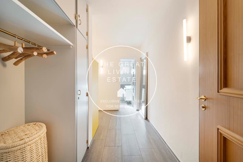 walk-in closet, hardwood flooring, wooden door, laundry basket, brass clothes rack
