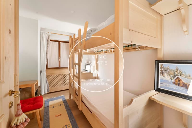 wooden bunk beds, wooden bed frame, wooden desk, chair, rug, picture frame, lamp