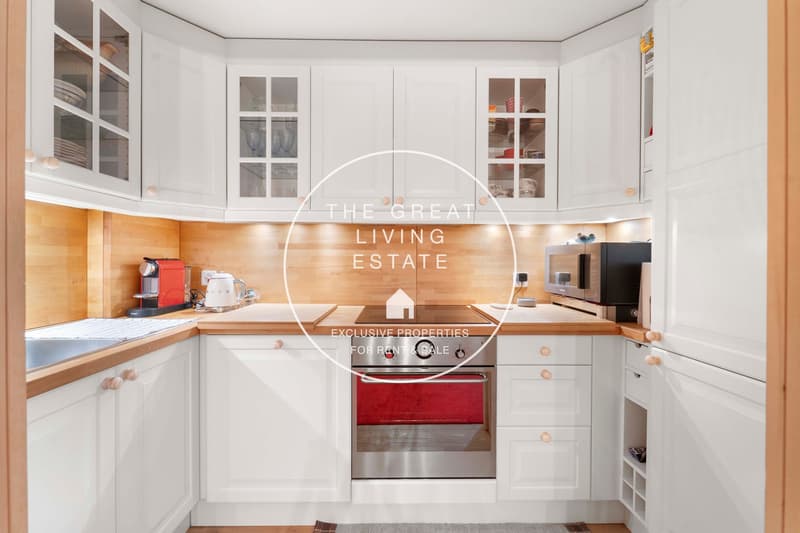 modern kitchen, white cabinets, wood countertops, stainless steel oven, dishwasher, washing machine
