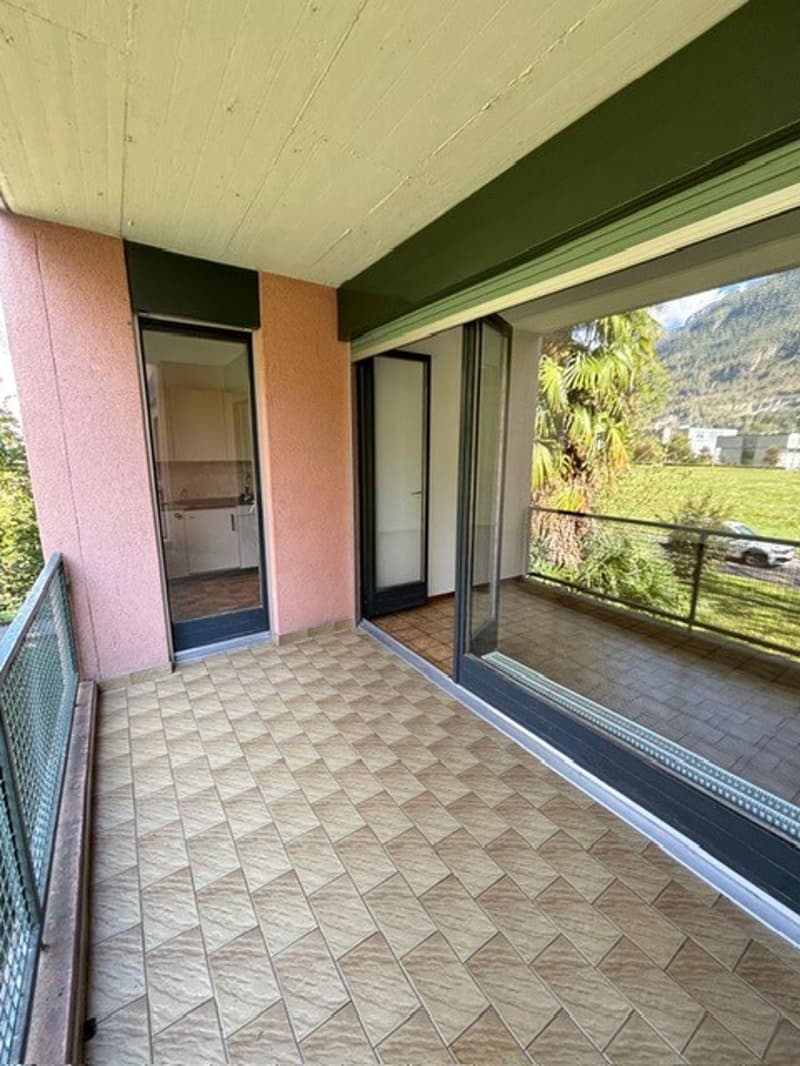 Empty balcony with wooden flooring, railings, and a view of a landscape