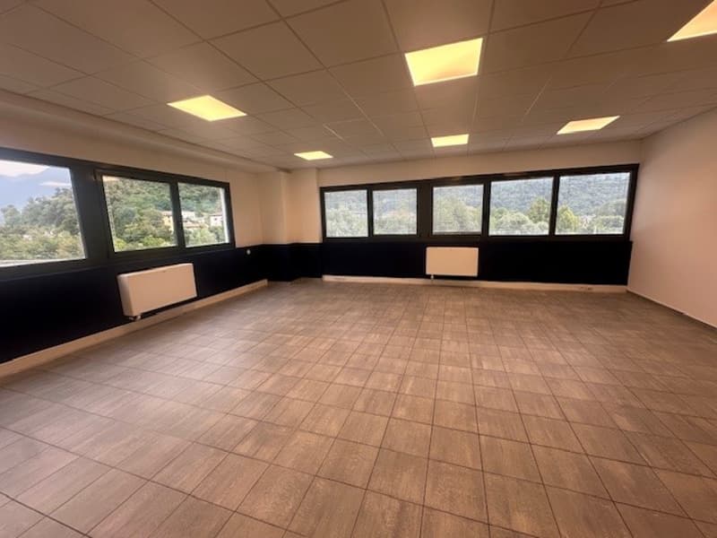 empty room, wooden floor, white radiators, large windows