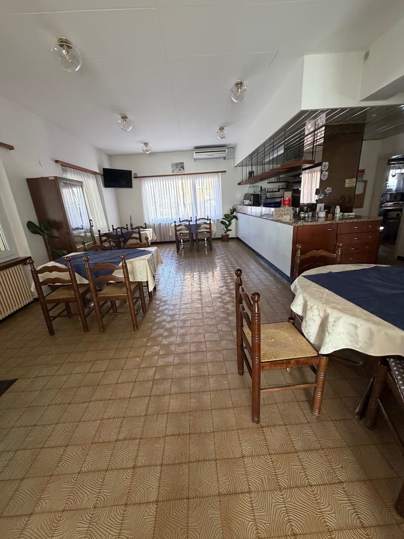 wooden chairs, wood tables, counter, cabinets, air conditioning, TV, radiator, decorative items on counter