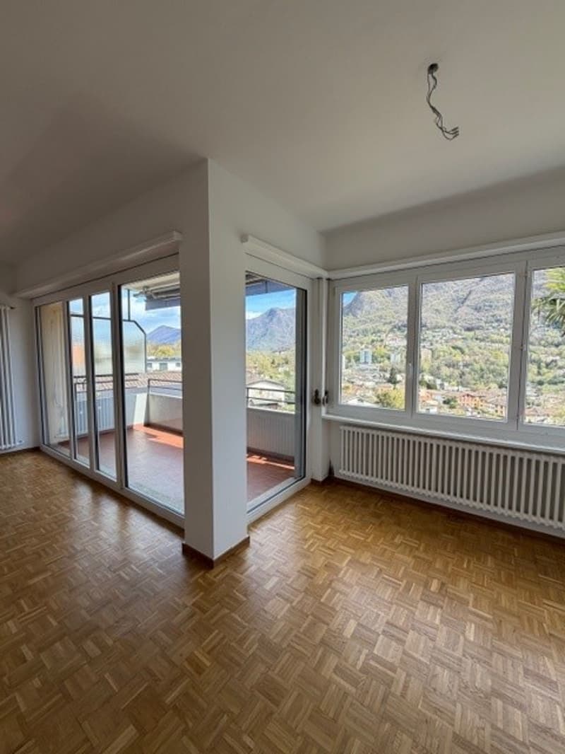 empty room, wooden floor, sliding glass doors, balcony, large windows, mountain view