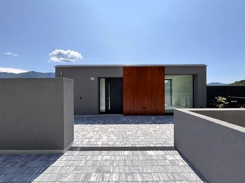 modern minimalist exterior, raised ground floor, grey stone floor, large wooden entrance