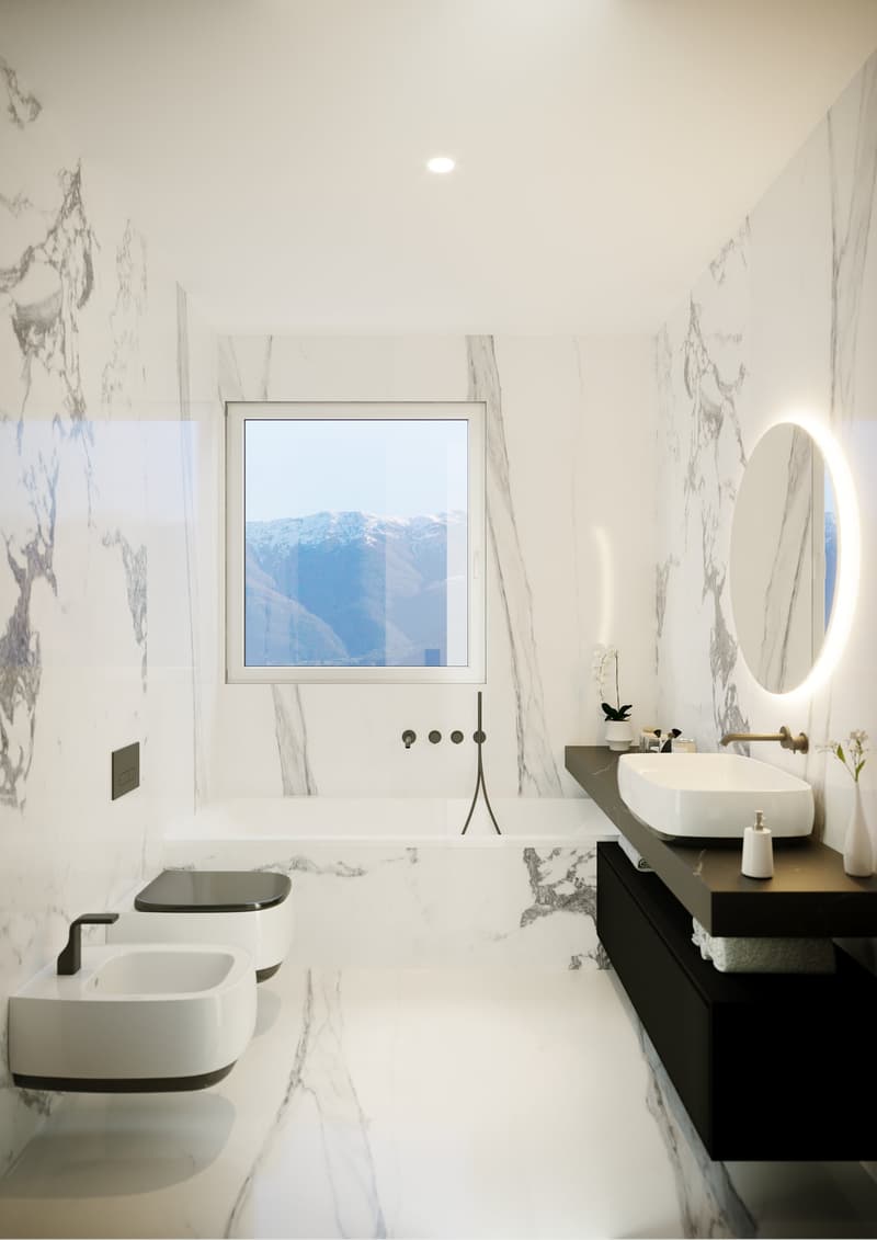 Spacious bathroom with marble-like walls, a large window with a scenic mountain view, a modern vanity with a vessel sink, and a round backlit mirror. The bathroom also features a toilet and a minimalist black and white color scheme.