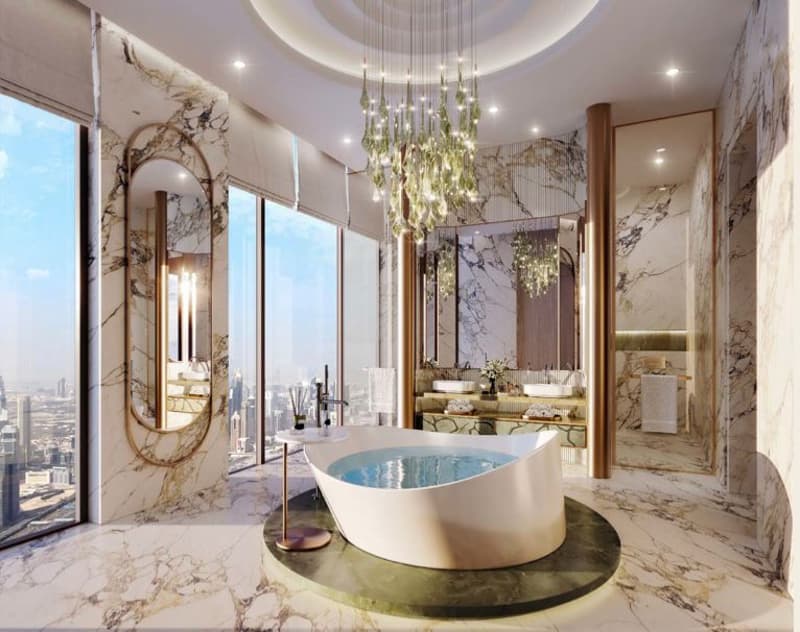 Circular freestanding tub, wall-mounted mirrors, round chandeliers, marble wall, large windows