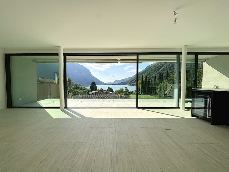 large glass windows, tiled floor, clear view of the mountains and lake