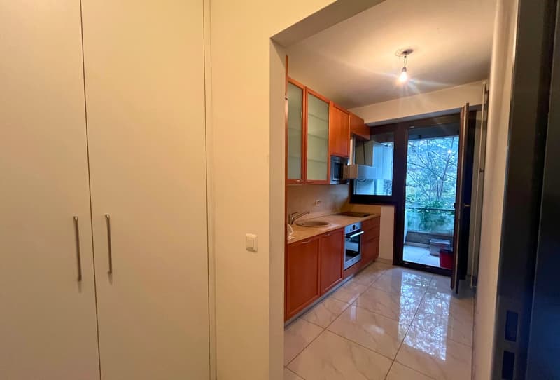 modern kitchen with appliances, open floor plan, large windows, balcony