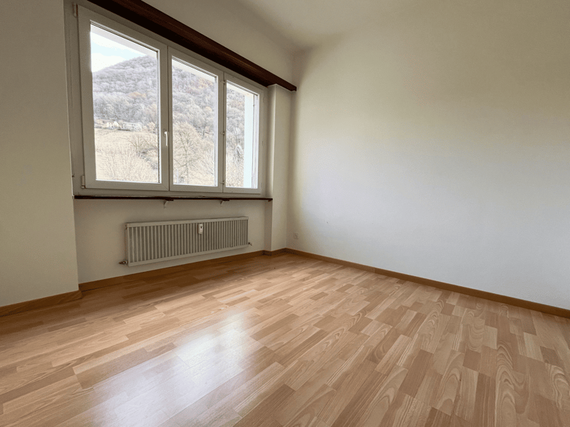 empty room, white walls, wooden floor, large windows, heater