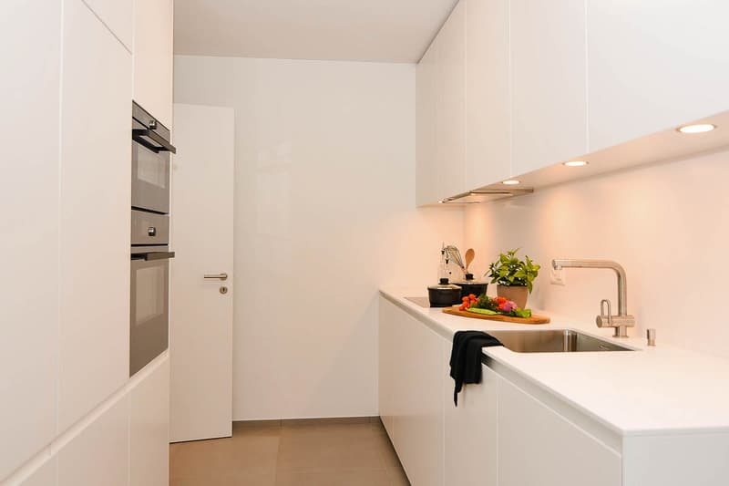 modern kitchen, white cabinets, stainless steel sink, gas stove, oven, dishwasher, white countertops