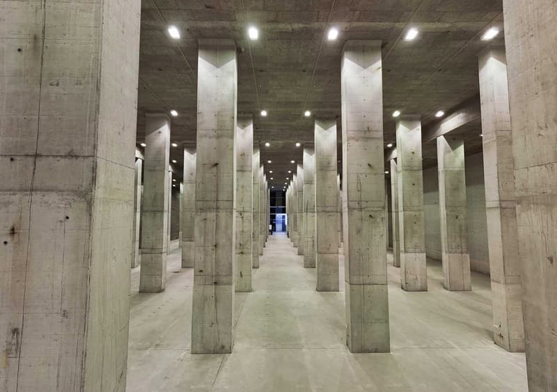 Concrete tunnel, concrete columns, concrete ceiling, concrete floor, lights on the ceiling