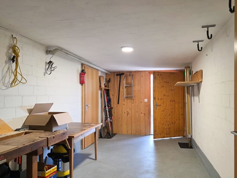 wooden storage room with floor for ski, ski equipment, boxes, wooden table