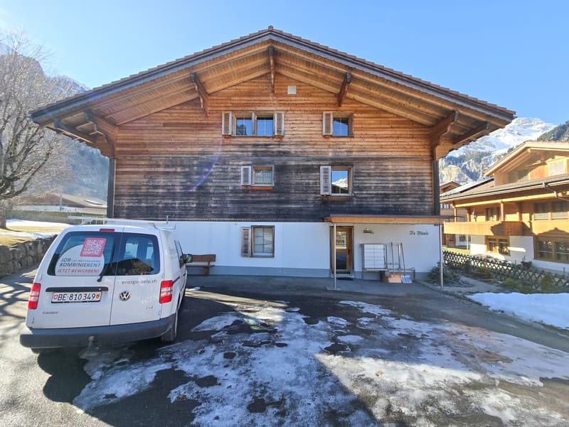 wooden house, white lower floor, windows, garage, bench, snow