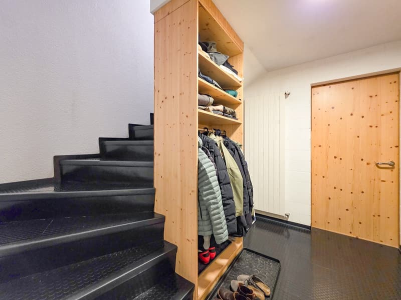wooden wardrobe, black stairs, wooden door, shoes, coats