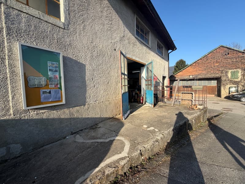 exterior view, cement wall, open garage, bulletin board, shadow