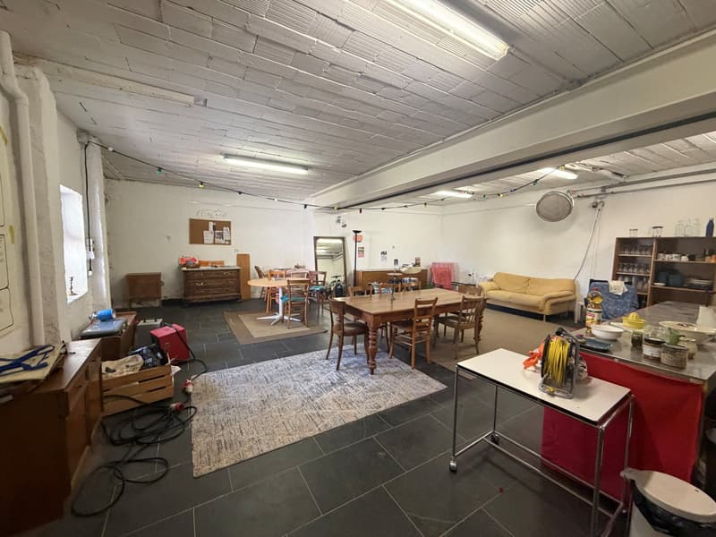 an empty room with wooden table, chairs, a couch, wooden cabinets, and other objects