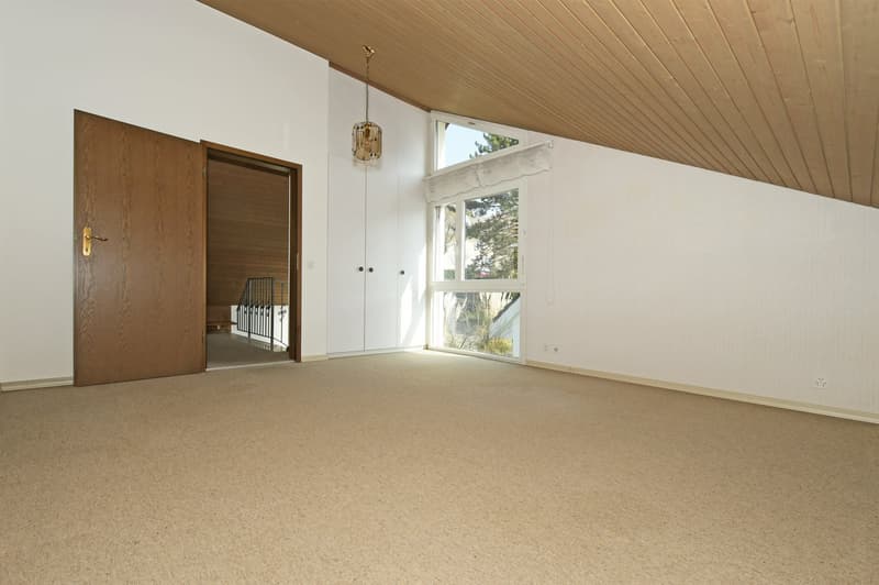 empty room, wooden ceiling, white walls, carpeted floor, open door, window with white frame