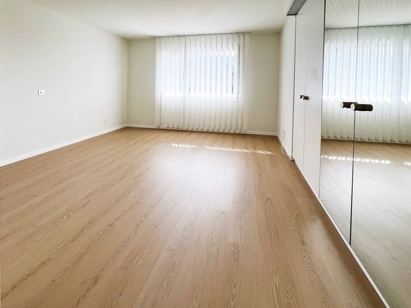 empty room, wooden floor, white walls, large window with white curtains, mirror