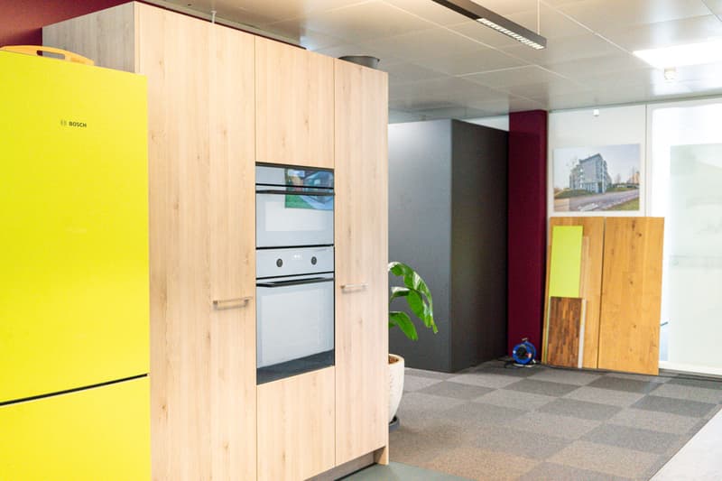 Modern kitchen with wooden cabinets, built-in Bosch appliances, and tiled flooring