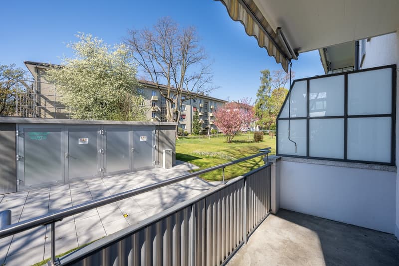 Metal railing, tiled floor, metal storage boxes, glass wall, metal handrail
