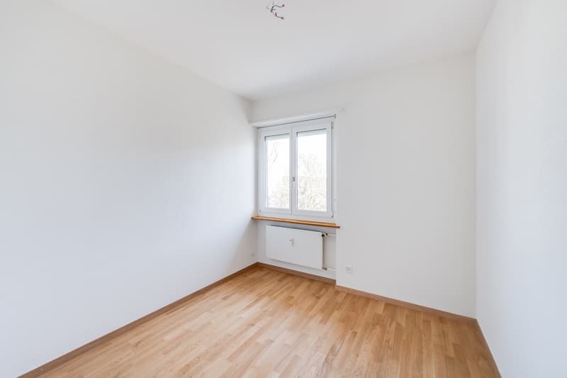 empty room, white walls, wooden floor, window, radiator