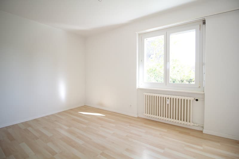 empty room, white walls, wooden floor, white radiator, window
