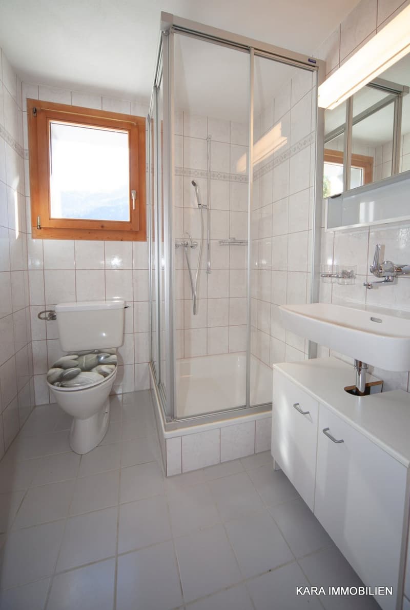 modern bathroom with shower, white walls and floors, white sink, silver faucet, toilet, window