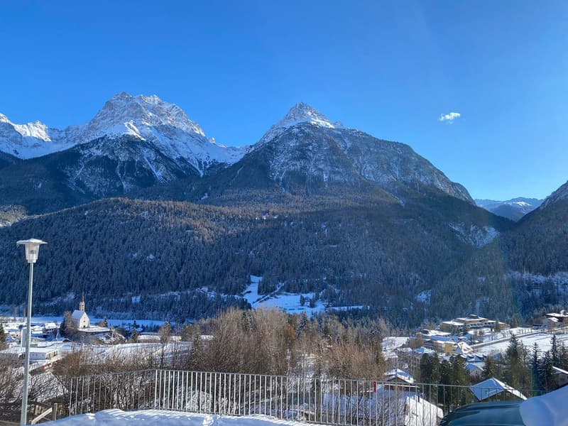 Snow-covered mountains, village, fence, road, lamp post, clear blue sky