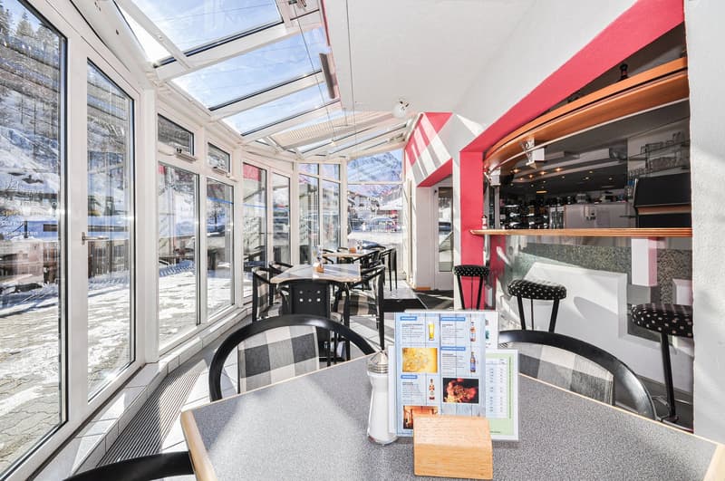 modern dining area with multiple windows and a glass roof