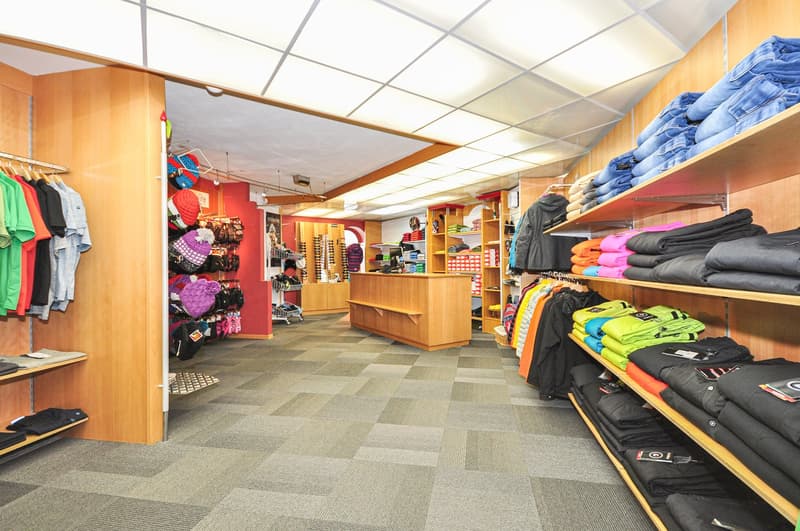 wooden shelves, clothes, desk, flooring, bright lighting, rack for hats