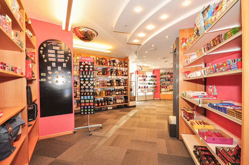 a store with shelves, a floor, many products, and a mirror