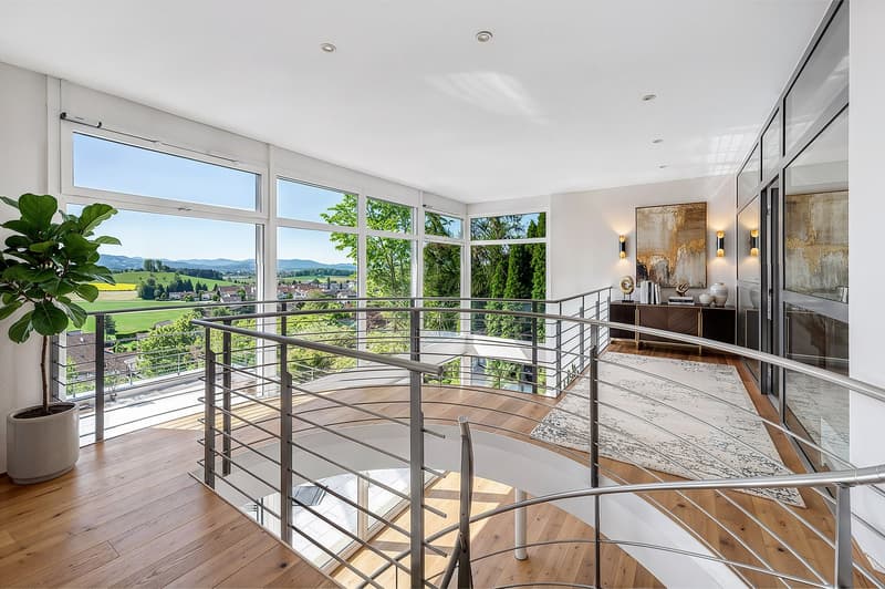 wooden floor, spiral staircase, large windows, view of the landscape, potted plant