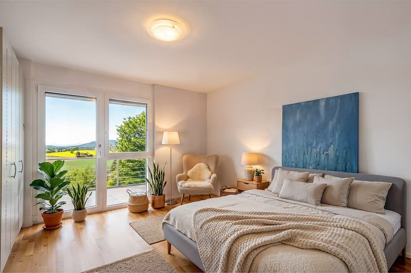 large bed, gray headboard, beige bedding, bedside tables, lamps, armchair, artwork, floor lamp, large windows, balcony, plants