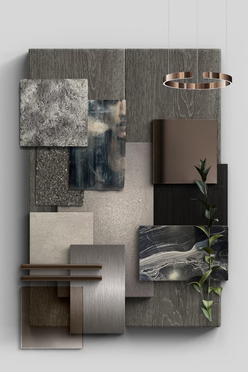 The image shows a material board or mood board with various textures and materials in shades of gray, black, and brown. The materials include wood panels, stone or marble, a furry gray fabric, and a plant element. There is also a circular light fixture vi