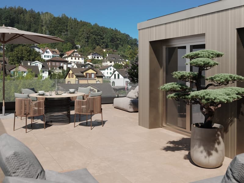 Outdoor dining area with table, chairs, and umbrella, potted plants, tiled floor, glass door, and scenic view of the town