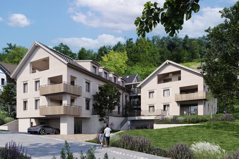 Modern apartment building with balconies, underground parking, and a car parked in the driveway.