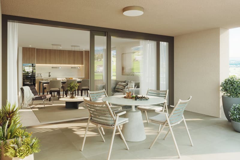 Dining area with table and chairs, open to a kitchen, large windows, balcony, plants, tiled floor