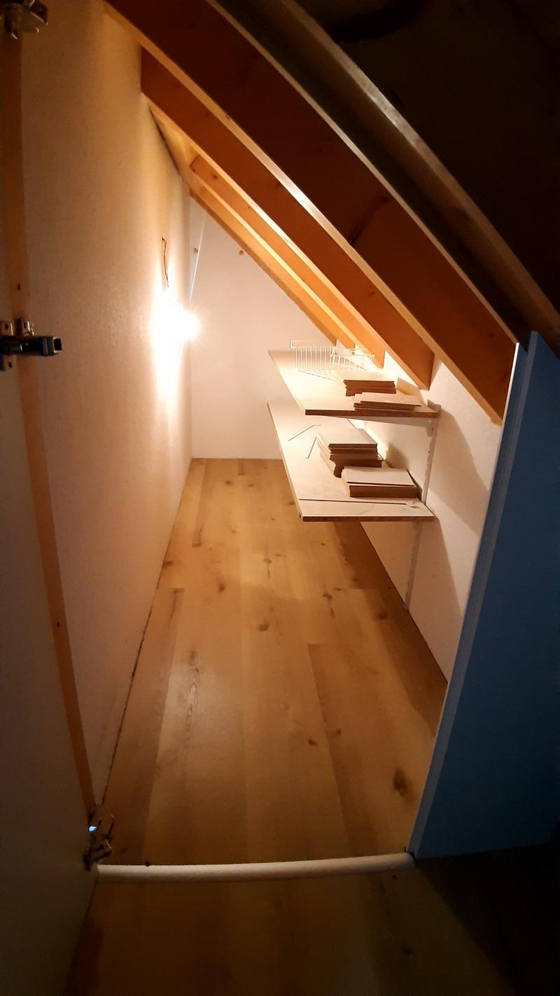 attic room, wooden floor, wooden beams, shelves, light