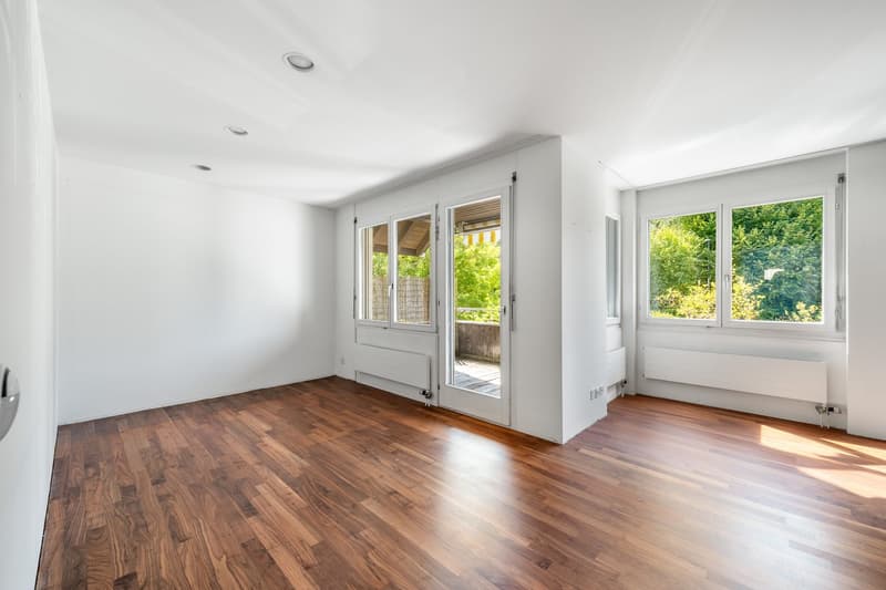 empty room, wooden floor, white walls, large windows, sliding doors to balcony, sunlight