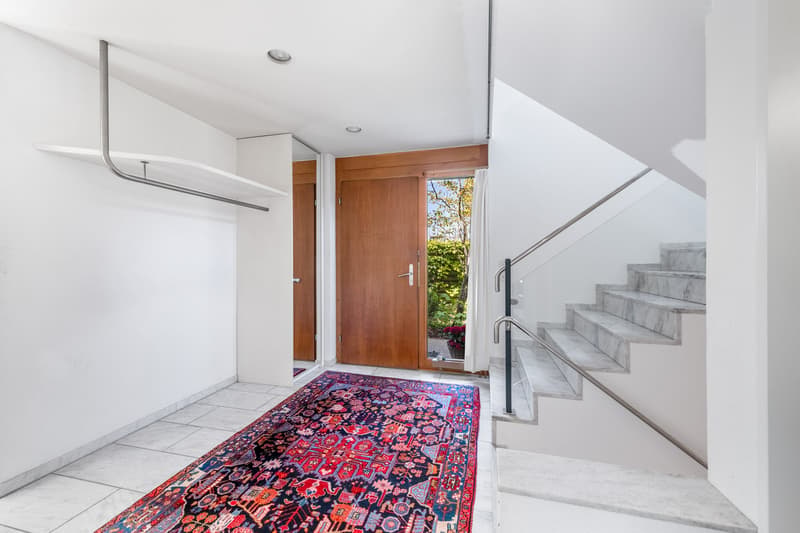 marble floor, tiled wall, staircase, wooden door, rug, balcony access