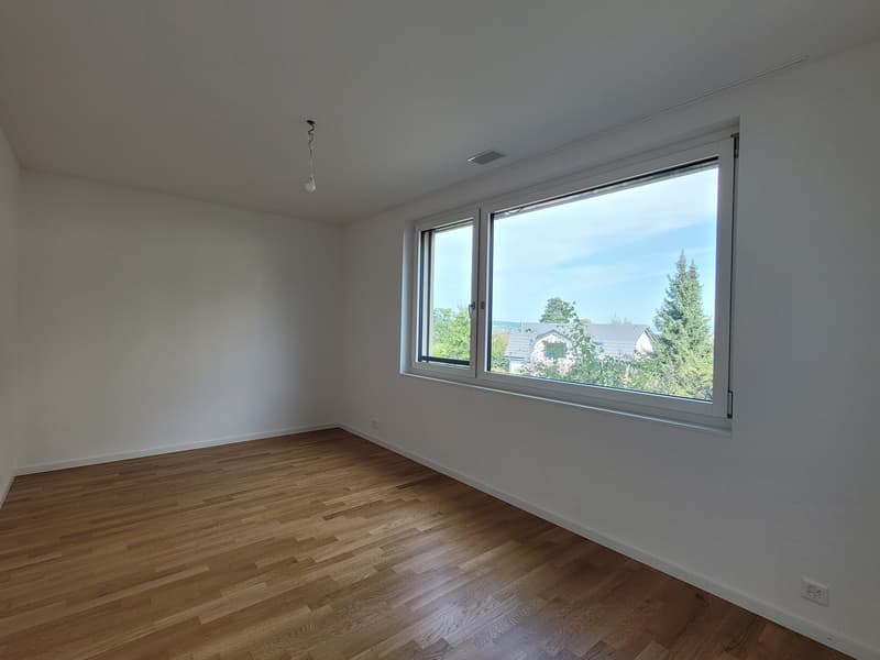 empty room, hardwood floor, white walls, large window with outdoor view