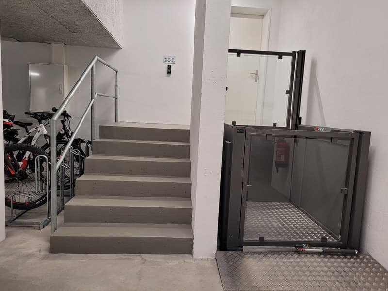 underground parking with stairs, lift, extinguisher, bicycles
