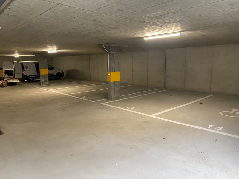 underground parking area, empty except for a van