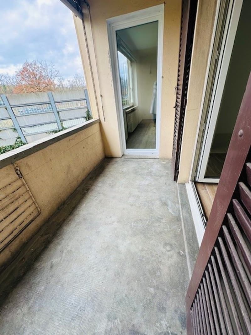 empty balcony with railings, glass doors, concrete floor