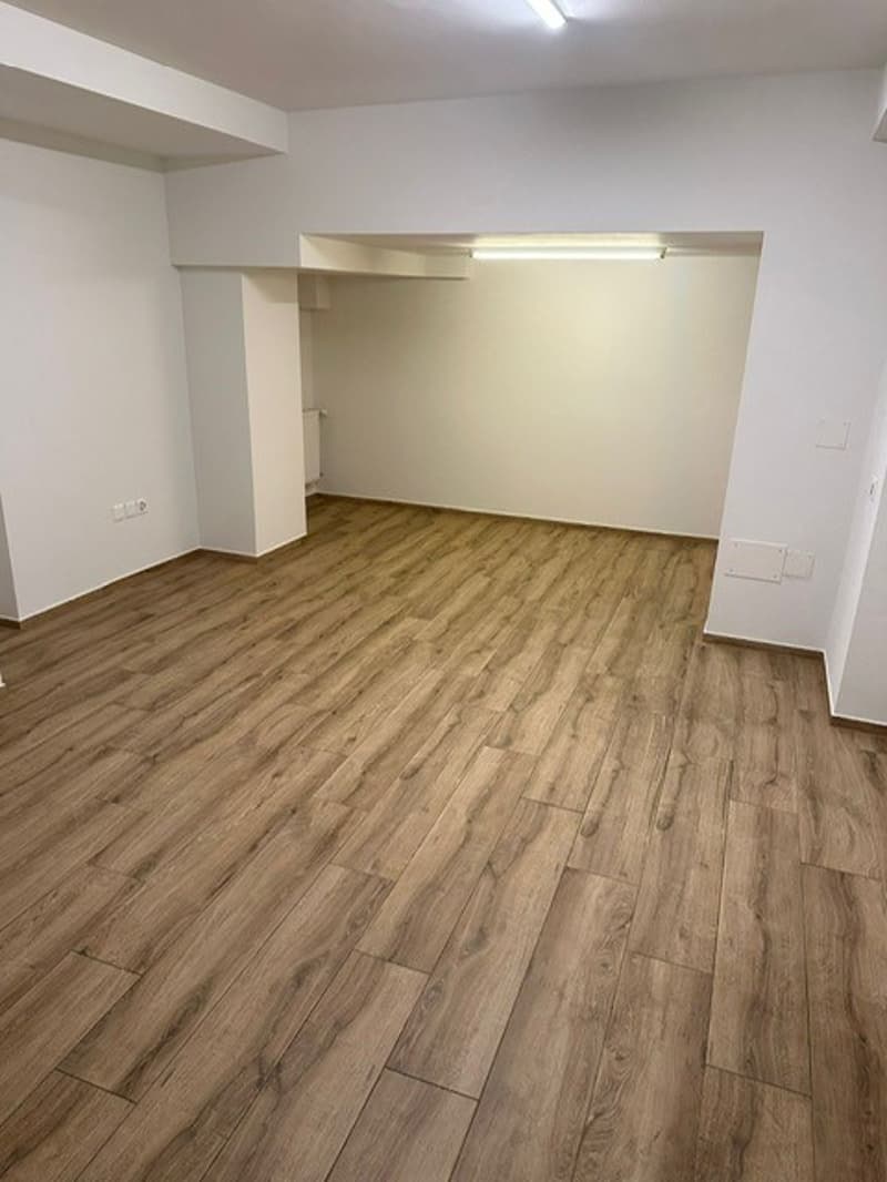 empty room, wooden floor, white walls, ceiling light, power outlets