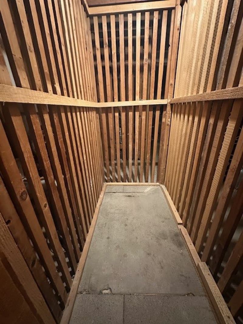 wooden walls, concrete floor, narrow passage